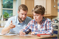 Male Home Tutor Helping Boy With Studies