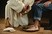 Jesus washing the feet of a modern man wearing jeans