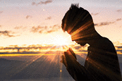 Silhouette of christian man hand praying