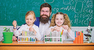 School children and teacher in science classroom.