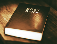 Holy Bible on the Small Aged Wooden Table.