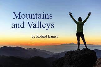 The title of this article is Mountains and Valleys with a female hiker with arms up outstretched on mountain top looking at view.
.