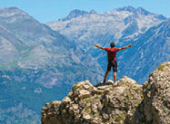 Male hiker standing on top of mountain in the Pyrenees.