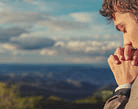 A young man is praying in the evening.