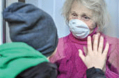 Grandmother in a respiratory mask communicates with her grandson through a window!