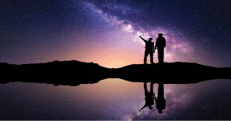 Milky Way with silhouette of a family, a father and a son