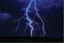 Night time lightning storm shooting lightning bolts.