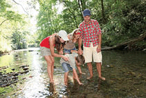 Family crossing a river.