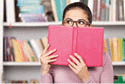 Young woman looking out of the book 