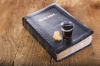Taking Communion with a cup of grape juice/wine and unleaven bread and the Bible.