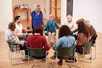 People holding hands and praying at Bible study group.