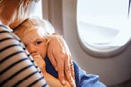 A woman traveling with little child by airplane.