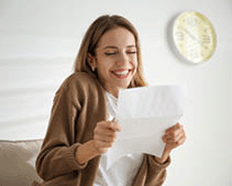 An excited woman reading letter.