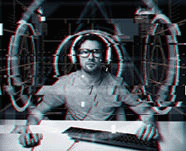 Hacker man in headset and eyeglasses with pc computer keyboard