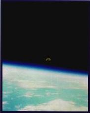 A rising moon as seen from above earths atmosphere