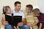 Father and children reading the Bible.