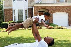 An African American father is playing with his son