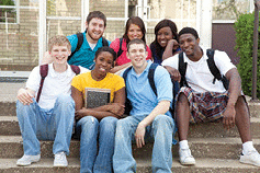 A multi-racial group of college students are meeting together.